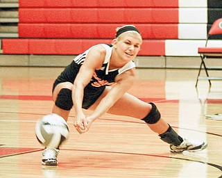 Springfi eld senior Sarah Sauerwein digs the ball during the Tigers’ match at Girard High on Monday.