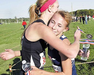 William D Lewis The Vindicator Fitch runner Carissa Jenkins, right hugs Canfield's Emma Lunne after winning meet at Canfield Tuesday 10--11. Lunne finished 2nd