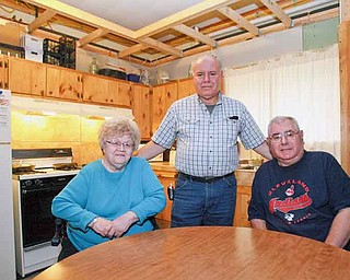 Napolitan, center, is remodeling his Austintown home to be disabled-accessible for his wife, Patty, and brother, Joe Napolitan Jr. He fears he may not be able to complete the project should he lose his job. 