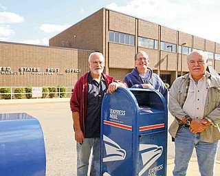 Chuck Myers, left, Doug Lammert and Dan Napolitan were all hired as electronic technicians Sept. 13, 1986. The three combined have 75 years of experience. They could all lose this jobs if the U.S. Postal service decides to close the distribution and processing center in downtown Youngstown.