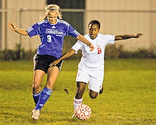 Cardinal Mooney’s Lindsey Parkins (8) battles for possession of the ball with Cuyahoga Valley Christian Academy’s Katie Cook (9) during a soccer match Wednesday in Struthers. Mooney won 3-1.