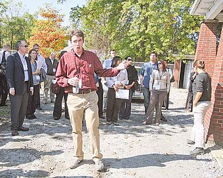 Youngstown Neighborhood Development Corp. deputy director Ian J. Beniston discusses urban agriculture and development at an urban farm on Youngstown’s South Side. The tour was part of the Ohio CDC Association’s annual conference.