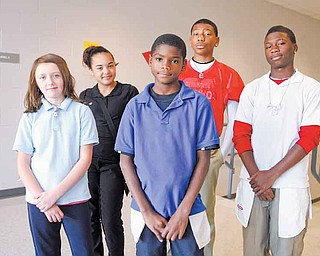 Volney Rogers Academy students, from left, Hannah Coleman, a sixth-grader; Markyra Ortello, seventh-grader; Shannon Dubose, sixth-grader; and Elijah Anderson and Rontelli Reed, both seventh-graders; sported their clothing inside-out Wednesday. The inside-out day was part of the school’s efforts to maximize student attendance during Average Daily Membership week, which runs through Friday.