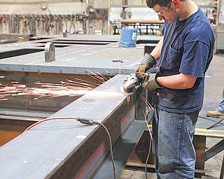 JESSICA M. KANALAS | THE VINDICATOR..Specialty Fab employee Bill Shilott grinding .. something.. Karl said he'd fill in captions.. ..-30