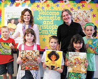 Illustrators Jeanette and Christopher Canyon spoke to students at Dobbins Elementary School on Friday. From left, Jacob Antil, 9; Brooke Chandler, 7; Mike Nicholudis, 6; Isabella Khoury, 5; and Emily Frost, 9, display works illustrated by the Canyons.