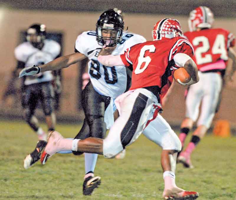 Youngstown East defender #80 (name not on roster) goes for the sack of Struthers quarterback #6 Tommy Kimbrough.