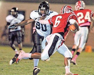 Youngstown East defender #80 (name not on roster) goes for the sack of Struthers quarterback #6 Tommy Kimbrough.