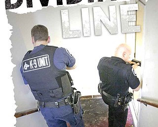 Liberty police officers Ray Buhala, left, and Robert Altier, right, inspect a vacant apartment building in the southern part of the township. As the township evolves from a rural to an urban setting, police are forced to fight a change in the types of crimes with a dwindling police force.