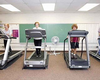 From left, Evelyn Myers, 75, of Girard; Marilyn Kobal, 78, of Girard; Teresa Sidoti, of Niles, who refused to give her age; and Paul O’Connor, 74, of Liberty, exercise before attending a Medicare seminar at the Girard Multi-Generational Center. Oct. 18 will mark the center’s 10th anniversary, but the facility awaits a crucial, 1.8-mill renewal levy vote in November.