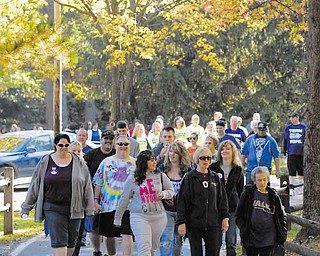 A group nears the finish line at the annual Alzheimer’s Walk at Boardman Township Park. More than 500 people participated in the event Saturday, including those with the disease and their family members, friends and caregivers.