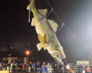 In this Jan. 1, 2011 photo, Wylie, a 20-foot long, 600-pound fiberglass walleye, touches down at midnight to welcome 2011 in Port Clinton, Ohio. Wylie is undergoing a $4,000 restoration. (AP Photo/Jonathon Bird, News Herald)