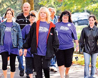 Johanna Morell Nuzzo, front, and her team cross the finish line together at Saturday’s Walk to End Alzheimer’s event. The event, which raised more than $35,000, was at Boardman Park.