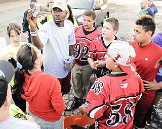 Gerald Hamilton hands out gloves to voulenteers.