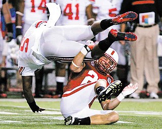 Ohio State quarterback Braxton Miller (5) is upended by Nebraska's Lance Thorell in the first half of an NCAA college football game in Lincoln, Neb., Saturday, Oct. 8, 2011. (AP Photo/Nati Harnik)