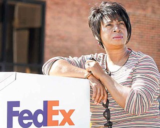 Selena Forte, 55, poses for a photo by a FedEx drop box Saturday, Oct. 8, 2011, in Cleveland. Forte thought she’d found a temporary job at FedEx that met her qualifications but a job recruiter for a temporary agency told her the company wouldn't consider her because she had been out of work too long. She's part of a growing number of unemployed workers who complain they are being screened out of job openings for the very reason they’re looking for work in the first place, they’re unemployed. (AP Photo/Tony Dejak)