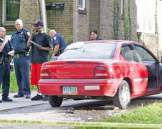 Youngstown police stand by at the scene of a Monday afternoon shooting in the 500 block of East Lucius Avenue. Two men were taken to St. Elizabeth Health Center for treatment. Part of the incident was captured on video, which confiscated by police.
