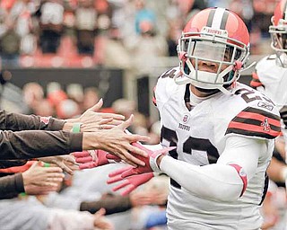 Cleveland Browns cornerback Joe Haden slaps hands with fans as he comes onto the field to face the Tennessee Titans in an NFL football game on Sunday, Oct. 2, 2011, in Cleveland. The Titans won the game 31-13. (AP Photo/Amy Sancetta)