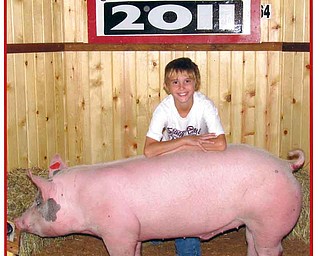 Cole poses with his 4-H pig Big Ben at the 2011 Canfield Fair.