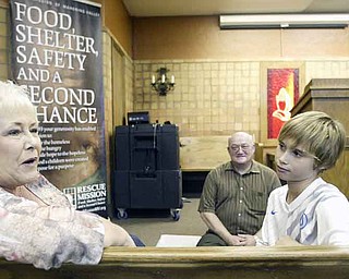 Cole Shehan, 12, of North Lima raised a pig he named Big Ben to show at the Canfield Fair. Big Ben’s buyer donated the pig to the Rescue Mission of the Mahoning Valley. Joining Cole on a tour of the mission were his grandmother, Pam Manchester of Boardman, and the Rev. David Sherrard, director of the mission.