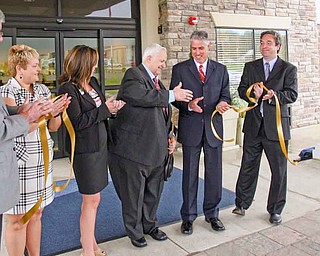 An official ribbon-cutting ceremony for Austintown’s new Holiday Inn Express and Suites was Wednesday morning. From left, assistant general manager Heidi Pelfrey, general manager KayLou King and owner Frank Pasqualetti celebrate with Brent Carnaha, of Seven Seventeen Credit Union and Atty. Jeffrey Lutz, who represents Pasqualetti, after cutting the ribbon.