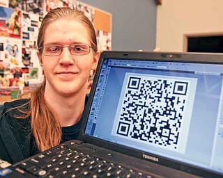 Calvin Neer, a senior from Jackson-Milton, shows off the Quick Response Code that links to a 30-second video ad about Mahoning County Career and Technical Center’s culinary arts program. Students in MCCTC’s interactive multimedia/visual art and design class completed marketing projects for the school’s programs.