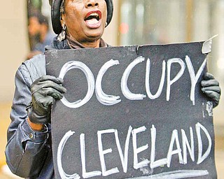 Mae Thompson, 67, protests Wednesday in Cleveland as part of the Occupy Wall Street movement. The demonstration is one of many across the country. An Occupy Youngstown protest will be Saturday in downtown Youngstown. The origins of the movement come from Canada and the Middle East.