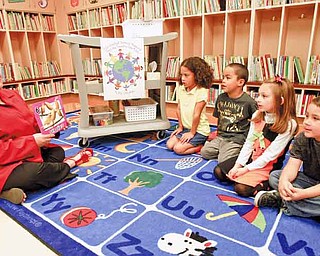 Linda Slater talks through the number line in Spanish with kindergartners, from left, Daphine Hendrix, Tyler Saunders, Kennedy Perline and Oylan James. She has taught Spanish in various forms for 13 years, but this is her first time teaching it to elementary students.