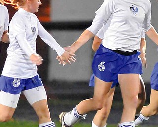 Lakeview’s Alyson Zurawick (8) congratulates teammate Ali Gagne (6) after Gagne scored a goal for the Bulldogs during Wednesday’s soccer match against the Champion Flashes in Cortland. The Bulldogs’ 3-2 win earned them the All-Amercian Conference’s National Division title.
