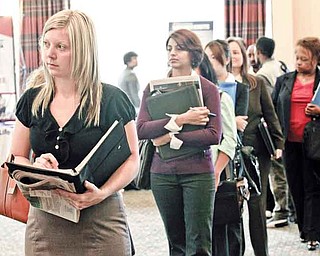 FILE - In this Sept. 14, 2011 file photo, Annelie Ingvarsson, left, waits in line to talk to potential employers during a National Career Fairs job fair, in Bellevue, Wash. The United States added 103,000 jobs in September, an improvement over this summer and just enough to calm fears of a new recession that have hung over Wall Street and the nation for weeks. (AP Photo/Ted S. Warren, File)