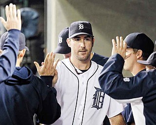Detroit Tigers starting pitcher Justin Verlander walks in the dugout after being relieved in the eighth inning in Game 5 of baseball's American League championship series against the Texas Rangers Thursday, Oct. 13, 2011, in Detroit. (AP Photo/Paul Sancya)