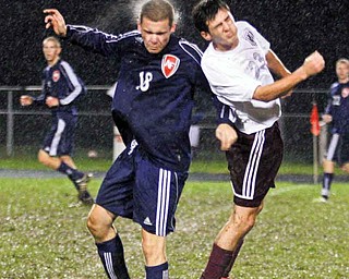Fitch’s Kyle Kosco (18) and Boardman’s Matt Horvatich (23) head the ball during a soccer rivalry Thursday in
Boardman. The game was called in the first-half due to lightning and will be rescheduled.