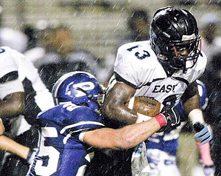 Youngstown East's George Leflore (13) is brought down by Poland's Mike Turnbull.