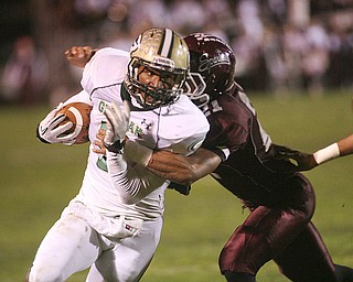 ROBERT K. YOSAY | THE VINDICATOR --..Glenoak #7 Dashawn Hall is brought down as he makes his cut from the backfield for a loss by Bdm #21 Devin Campbell - during first quarter action - .Glen Oak vs Boardman at Boardman High School -..--30-..(AP Photo/The Vindicator, Robert K. Yosay)