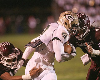 ROBERT K. YOSAY | THE VINDICATOR --..It takes two as Boardmans #21 Devin Campbell and Bdm #1 Dayne Hammond Stops Glenoak #7 Dashawn Hall during first half action -.Glen Oak vs Boardman at Boardman High School -..--30-..(AP Photo/The Vindicator, Robert K. Yosay)