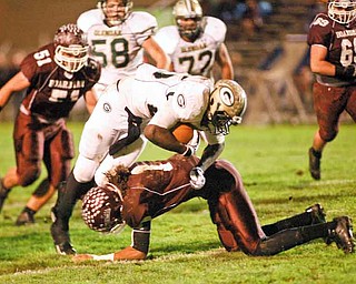 ROBERT K. YOSAY | THE VINDICATOR --..Crossing him down is #1 Bdm D Dayne Hammond as he takes down #25 Brionte Dunn as #51 Bdm Zach Machuga closes in .Glen Oak vs Boardman at Boardman High School -..--30-..(AP Photo/The Vindicator, Robert K. Yosay)