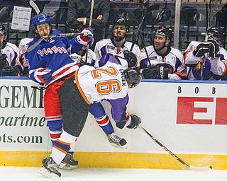 Des Moines’ Kevin Irwin, left, is checked at the boards by Youngstown Phantoms’ Alex Gacek (26) during Friday’s home opener at the Covelli Centre. The Phantoms won 4-2.
