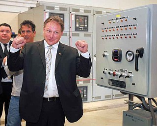 Struthers Mayor Terry Stocker fires up two methane generators at the city’s wastewater-treatment plant. The city cut the ribbon on the generators, which were built with federal stimulus funds, Friday morning. The generators run on methane gas.