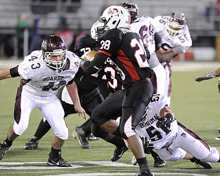 Boardman's #43 Joseph Mikesell and #51 Zach Machuga looks for the tackle of McKinley's #28 Sa'Veon Holloway on a running play.