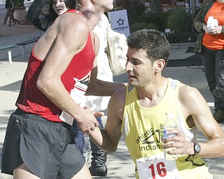 William D. Lewis|The Vindicator Third place runner Andrew Carnes, left, get  congrat form winner Aziz Atmani at end of race.