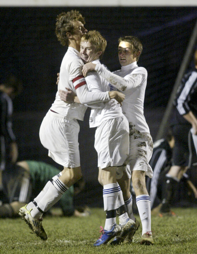 William D. Lewis|The vindicator  Lakeview's Matt Black, left, gets congratulations from team mates Matt Pasternak, center and Zack Wolf after scoring a 1rst period goal against Canfield Monday at Lakview.