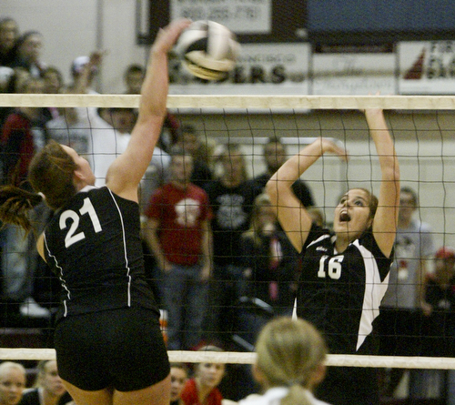  William D. Lewis|The Vindicator Salem's #21 Kathethrine Stiff tips the ball over the net while Canfield's Nicole Luklan defends Thursday at Boardman.