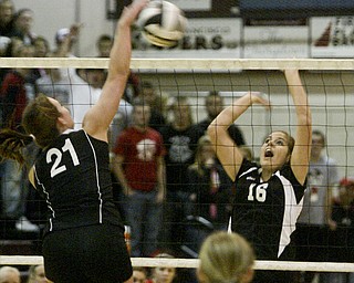  William D. Lewis|The Vindicator Salem's #21 Kathethrine Stiff tips the ball over the net while Canfield's Nicole Luklan defends Thursday at Boardman.