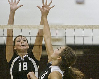 William D. Lewis|The Vindicator Salem's #6 NO NAME IN PROGRAM shoots the ball over the net while Canfield's Holly Rolla defends Thursday at Boardman.