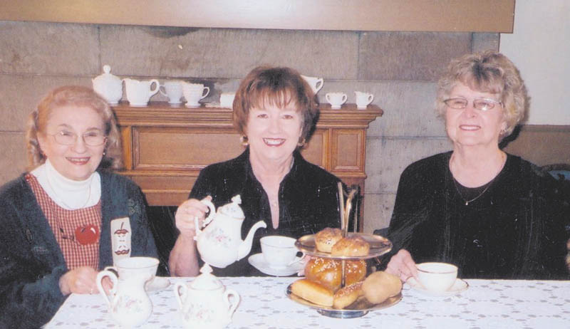 Preparing for the Austintown Historical Society’s Christmas Tea are, from left, Rae Jeanne Mollica, Marge Goldner and Joyce Pogany.