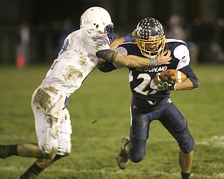 ROBERT  K.  YOSAY  | THE VINDICATOR --..Trying to bust thru the  backfield is McDonalds #29  Steven Vidman as Western Reserves #2  Donnie Bolton takes him down -  near the end of the second quarter .Western Reserve Blue Devils ( white) vs McDonald Blue Devils at McDonald ..--30-..(AP Photo/The Vindicator, Robert K. Yosay)