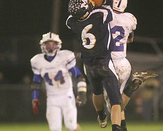 ROBERT  K.  YOSAY  | THE VINDICATOR --..Western Reserves #2  Donnie Bolton knocks away a pass intended for #6  Matt Morell -McDonald-  as Western Reserve #44  Dan Zilke looks on-.Western Reserve Blue Devils ( white) vs McDonald Blue Devils at McDonald ..--30-..(AP Photo/The Vindicator, Robert K. Yosay)