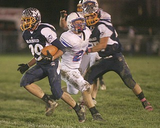 ROBERT  K.  YOSAY  | THE VINDICATOR --..McDonalds #29  Steven Vidman  cuts by Western Reserves #23 Jon Timko  as he goes for a first down. during first half action.Western Reserve Blue Devils ( white) vs McDonald Blue Devils at McDonald ..--30-..(AP Photo/The Vindicator, Robert K. Yosay)