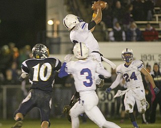 ROBERT  K.  YOSAY  | THE VINDICATOR --..Western Reserves #6   Jeff Clegg goes up above the receiver to intercept the pass away from McDonalds #10 Cameron Ifft  and Wester Reserves #3  Tim Cooper -  he returned the reception in the second  quarter for more than 30 yards -.Western Reserve Blue Devils ( white) vs McDonald Blue Devils at McDonald ..--30-..(AP Photo/The Vindicator, Robert K. Yosay)