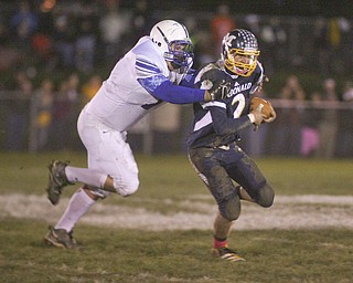 ROBERT  K.  YOSAY  | THE VINDICATOR --..Western Reserves #77   Aaron Halls - takes down McDonalds QB #2 Christian Rusinowski  for a 10 yard loss during second quarter action - Western Reserve Blue Devils ( white) vs McDonald Blue Devils at McDonald ..--30-..(AP Photo/The Vindicator, Robert K. Yosay)