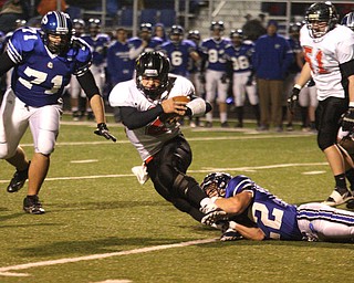 FOOTBALL - (2) Jordan Italiano of Canfield tries to get away from (22) Jerry Lawman Friday night in Poland. - Special to The Vindicator/Nick Mays